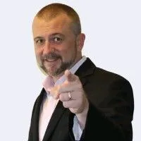 Darin Branch in a dark jacket, pointing toward the camera